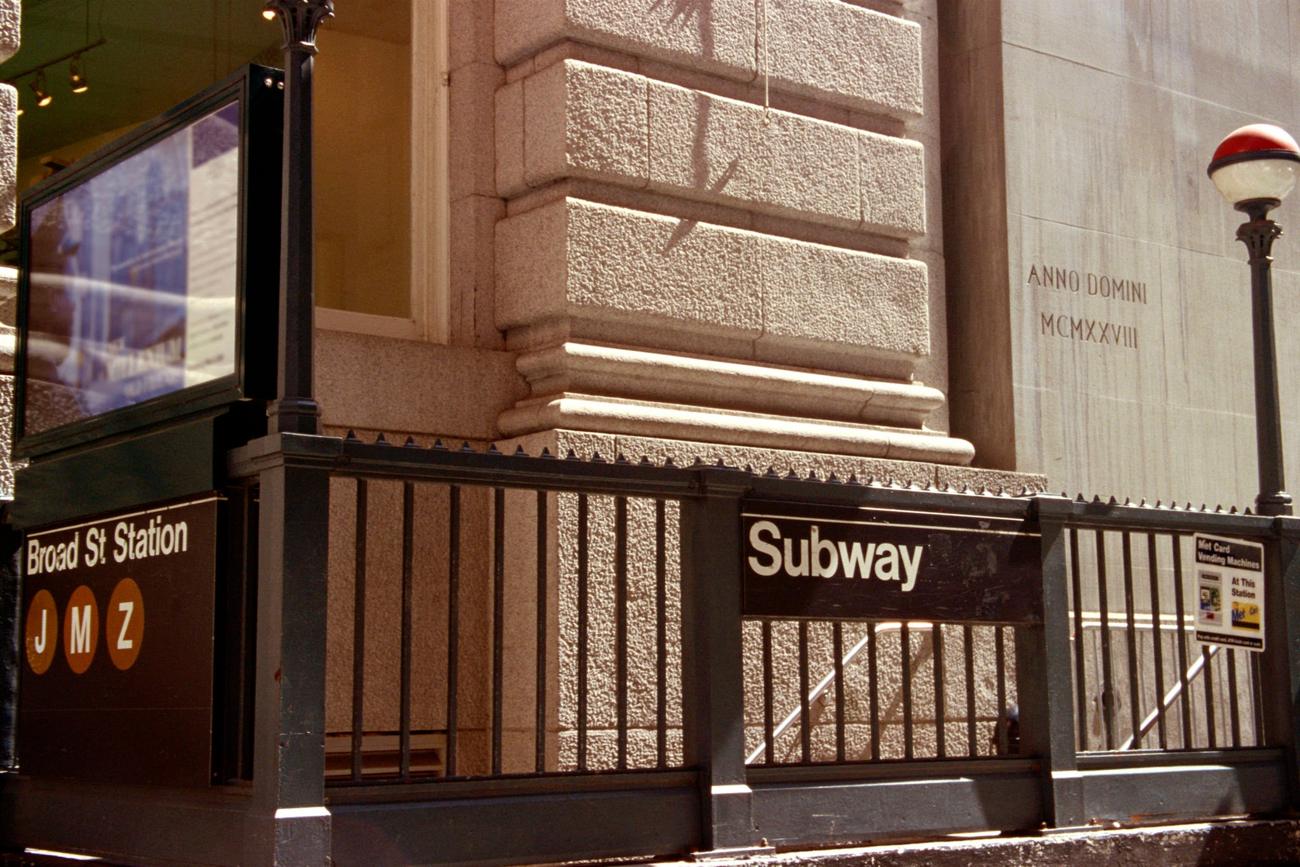 A subway ad about evolution, photographed on a platform
