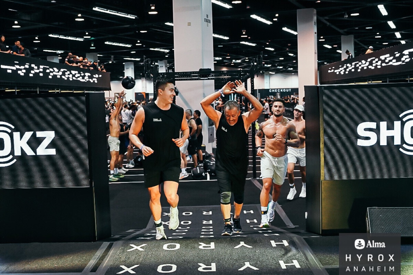 Cesar and his dad crossing the Hyrox finish line together in Team Cardenas shirts